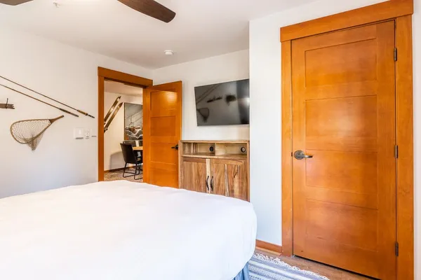 a bedroom with a bed and a flat screen tv