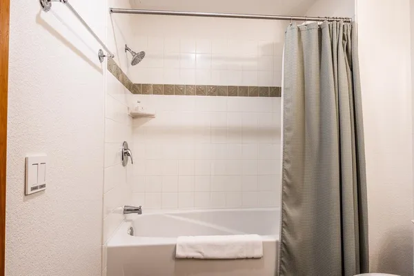 a bathroom with a shower and a bath tub
