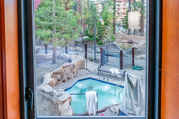 a view of swimming pool with outdoor seating and lake view