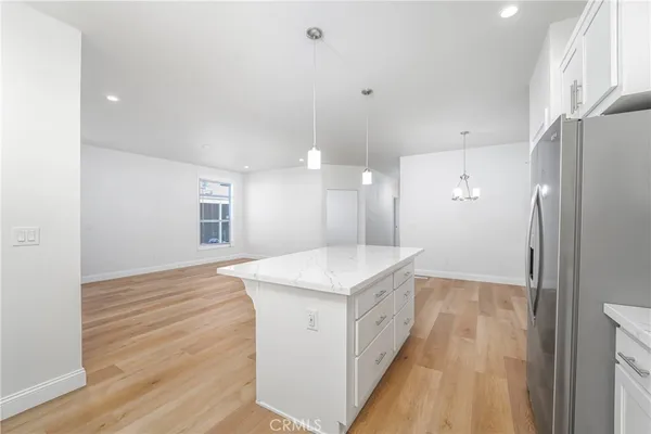 a kitchen with appliances a sink and cabinets