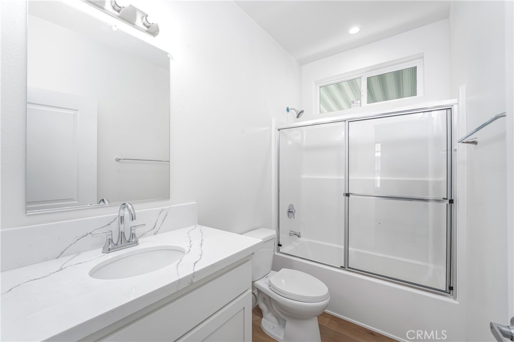 14851 Jeffrey Road, Unit 145 Irvine, CA 92618 - Photo 21 of 32 a bathroom with a granite countertop sink toilet and shower