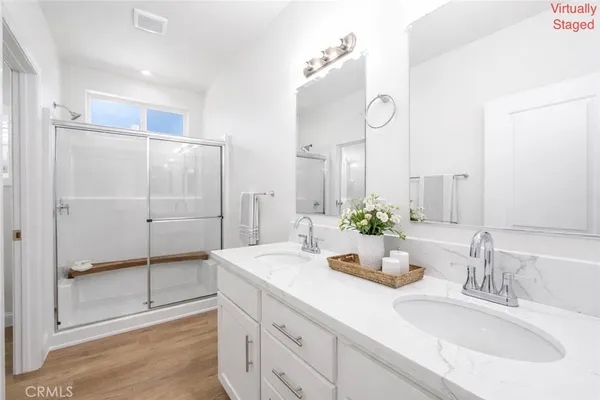 a open kitchen with kitchen island white cabinets stainless steel appliances and window