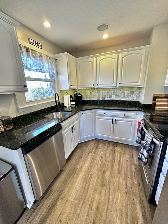 75 Coburn Road Berlin, MA 01503 - Photo 13 of 39 a kitchen with stainless steel appliances granite countertop a stove a sink and a microwave