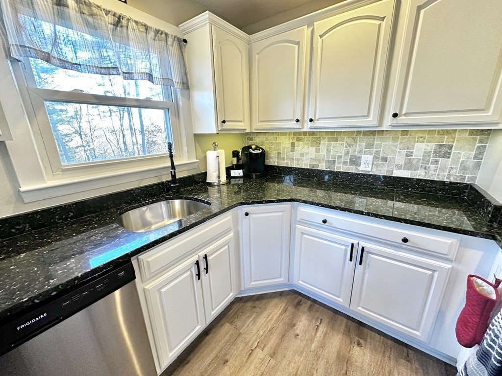 75 Coburn Road Berlin, MA 01503 - Photo 15 of 39 a kitchen with granite countertop a sink a stove and cabinets