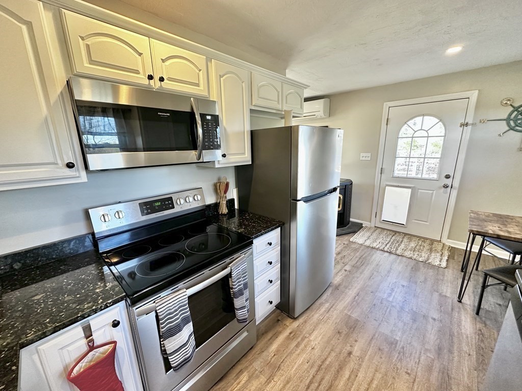 75 Coburn Road Berlin, MA 01503 - Photo 16 of 39 a kitchen with stainless steel appliances a stove a microwave a sink and cabinets