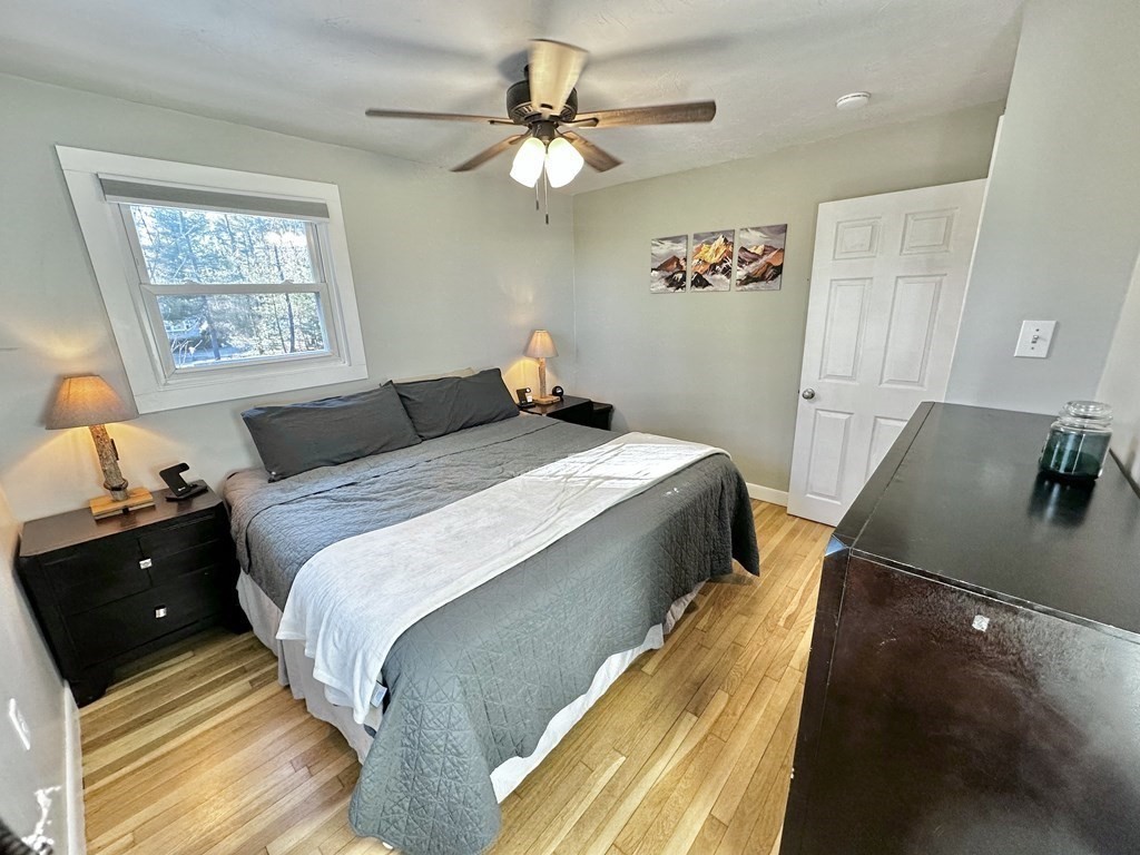 75 Coburn Road Berlin, MA 01503 - Photo 21 of 39 a bedroom with a bed and a chandelier
