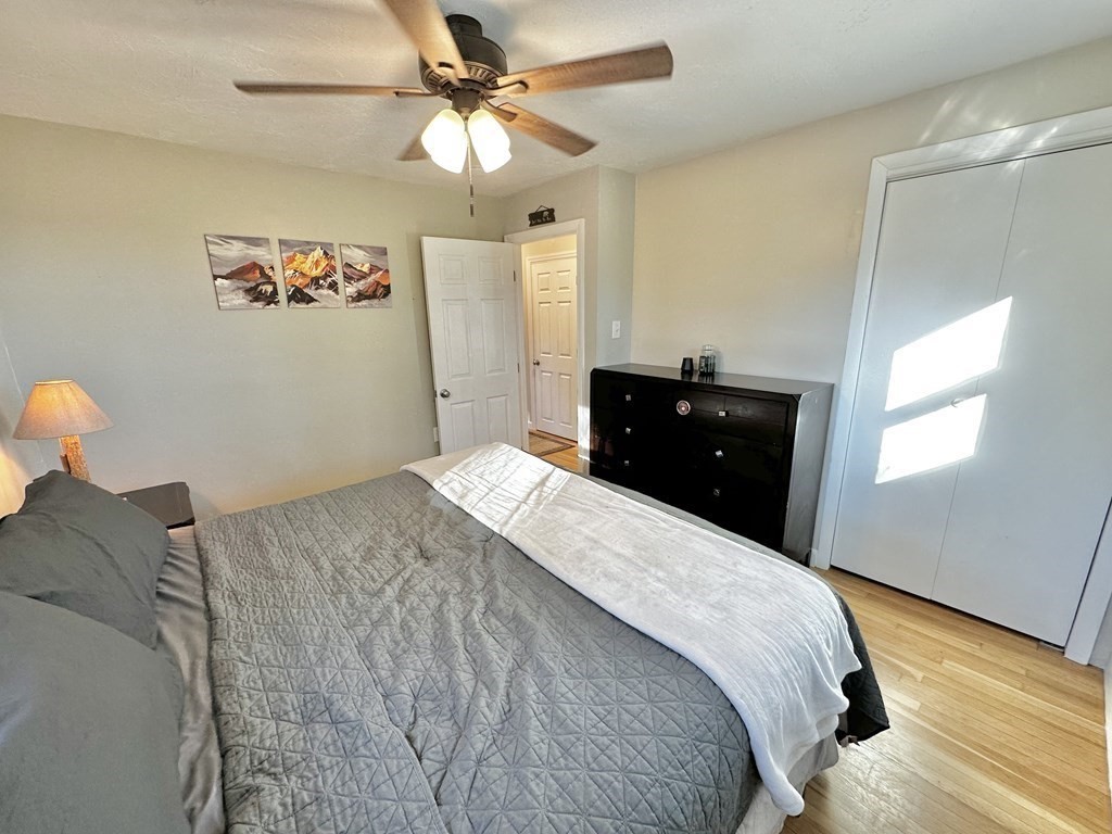 75 Coburn Road Berlin, MA 01503 - Photo 22 of 39 a bedroom with a bed and a chandelier