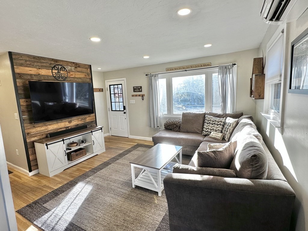 75 Coburn Road Berlin, MA 01503 - Photo 8 of 39 a living room with furniture and a flat screen tv