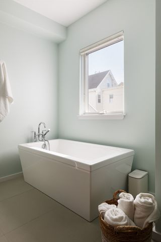 a white bath tub sitting next to a white toilet