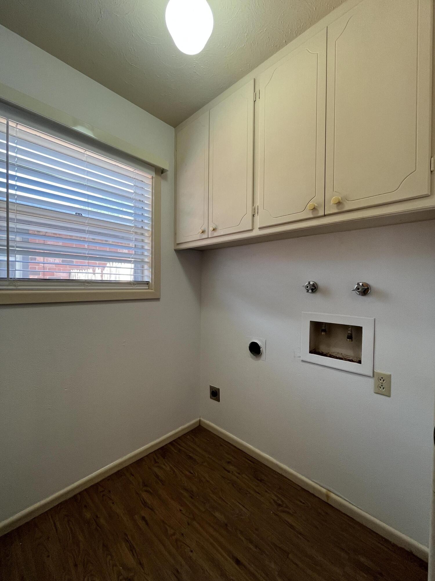 3614 56th Street Lubbock, TX 79413 - Photo 11 of 30 a view of an empty room with wooden floor and a window