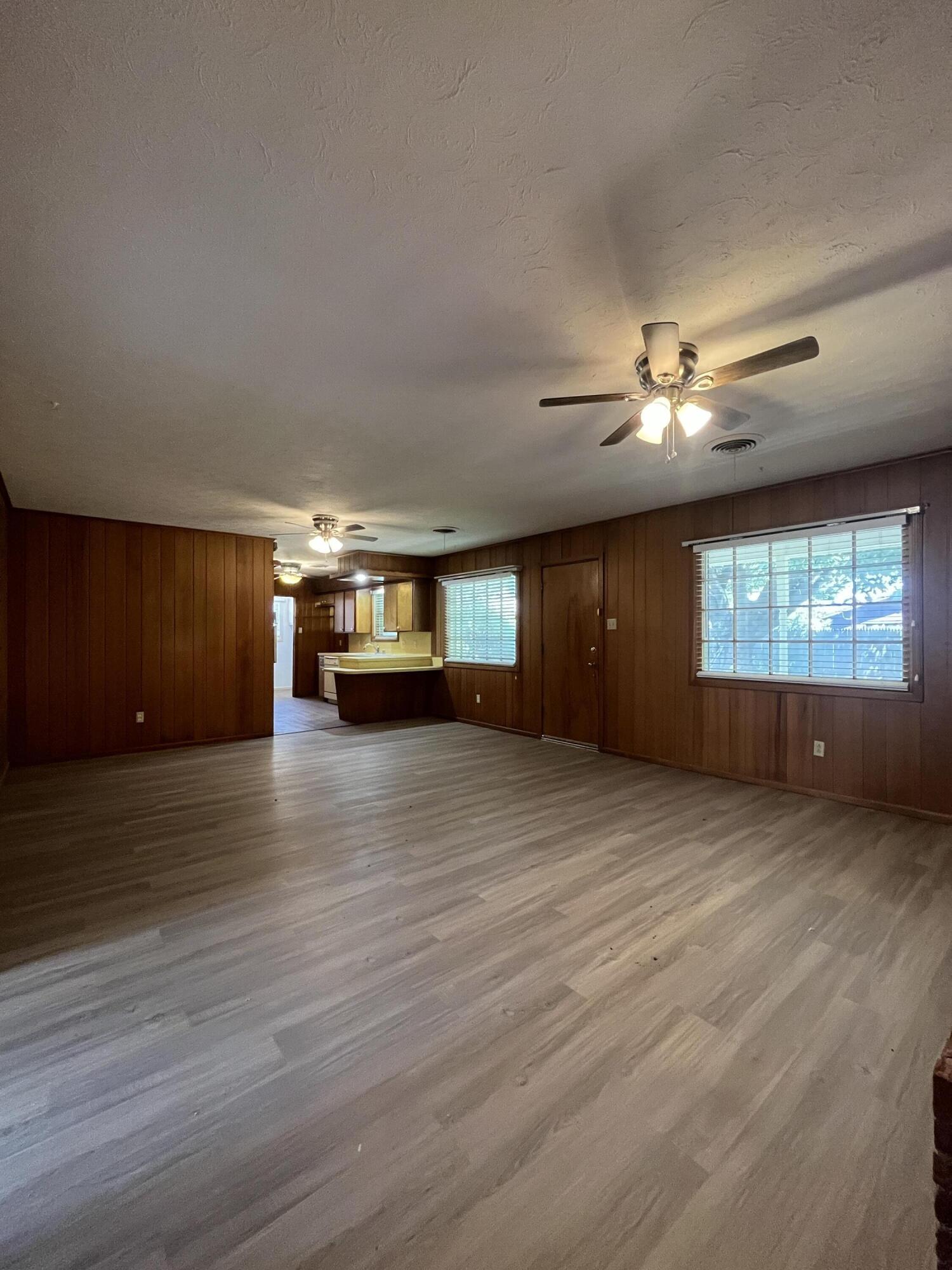 3614 56th Street Lubbock, TX 79413 - Photo 7 of 30 a view of an empty room with a window and fireplace