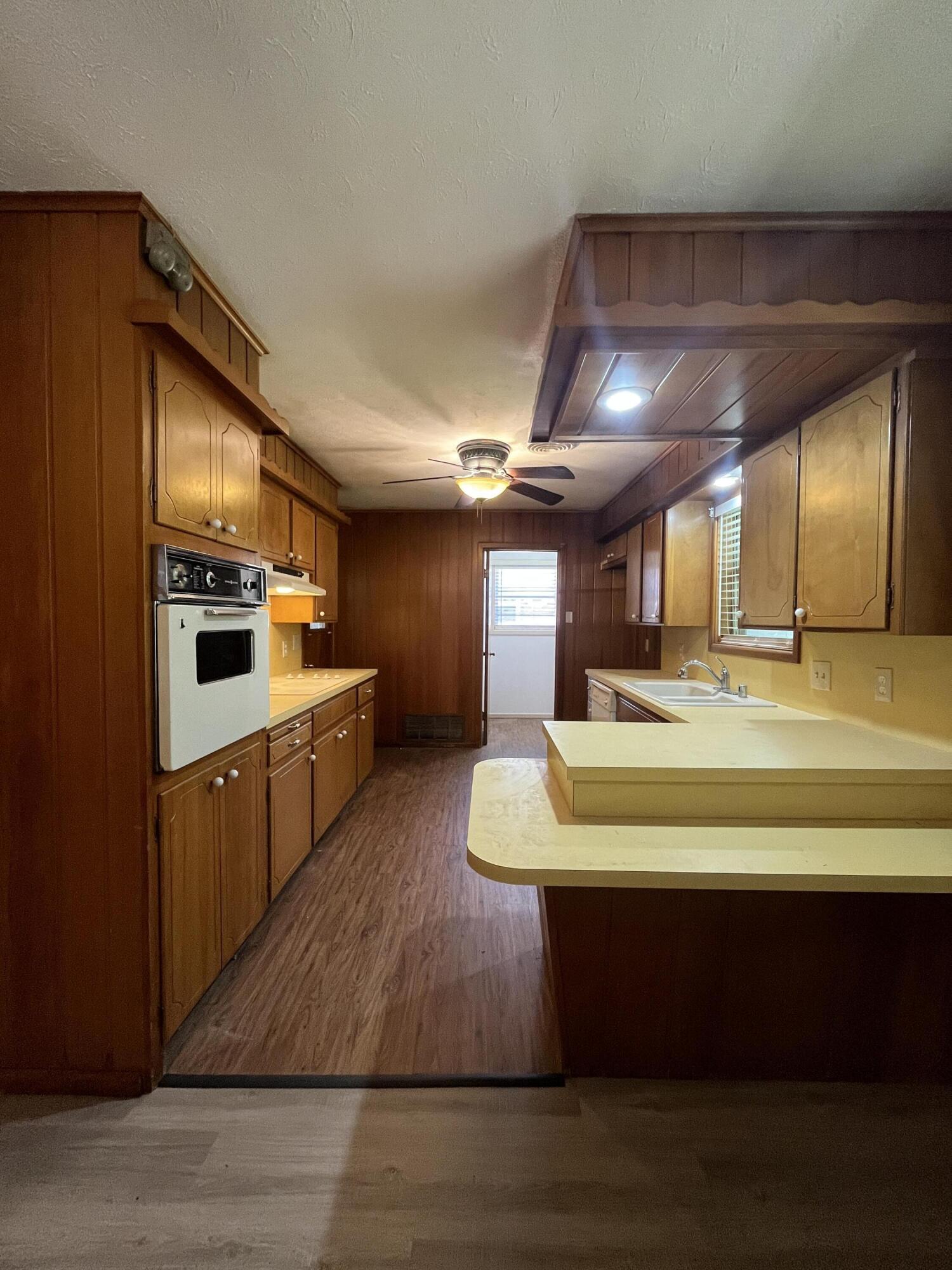 3614 56th Street Lubbock, TX 79413 - Photo 8 of 30 a large kitchen with stainless steel appliances kitchen island granite countertop a large counter top and stove