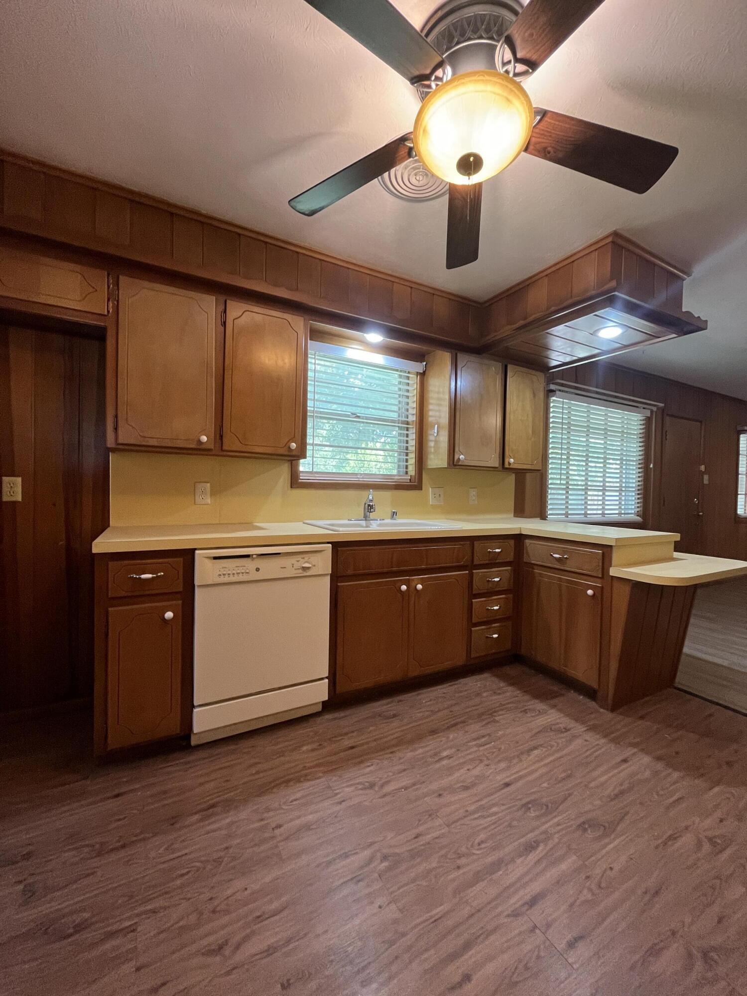 3614 56th Street Lubbock, TX 79413 - Photo 9 of 30 a large kitchen with stainless steel appliances wooden floors a stove a oven and a microwave