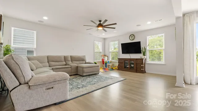 a living room with furniture and wooden floor