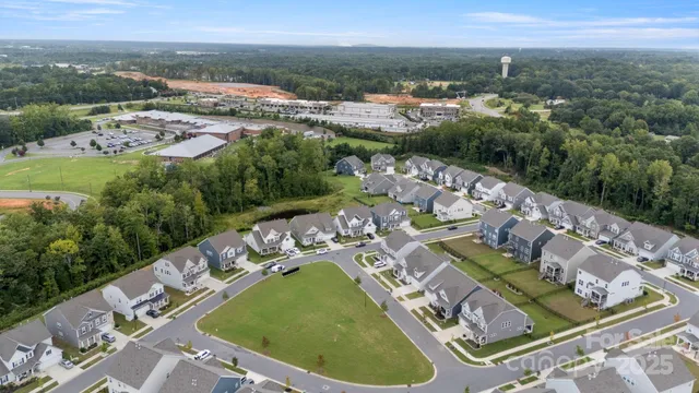 an aerial view of residential houses with outdoor space and parking