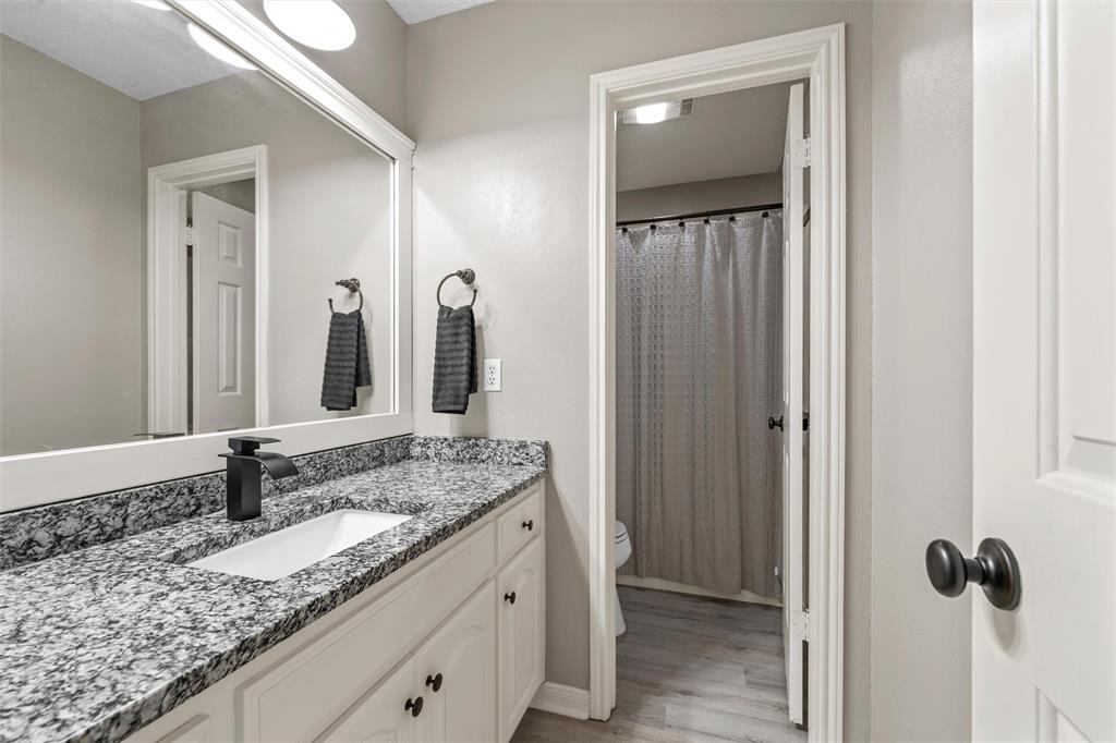 112 Briar Ridge Drive Hewitt, TX 76643 - Photo 10 of 15 Bathroom vanity featuring a rectangular undermount sink, a sleek black faucet, and a patterned stone countertop