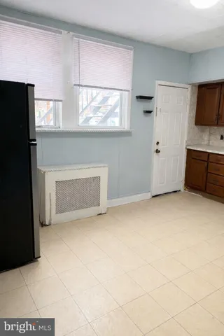 a view of empty room with a fireplace and a flat screen tv