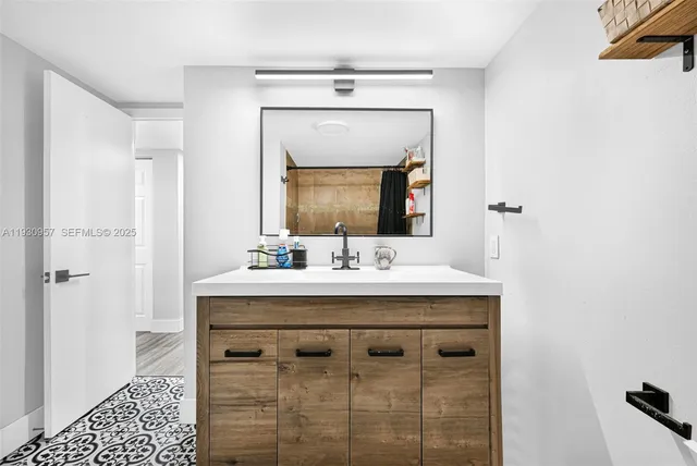 a bathroom with a sink vanity and a mirror
