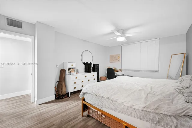 a bed room with a bed and a chandelier