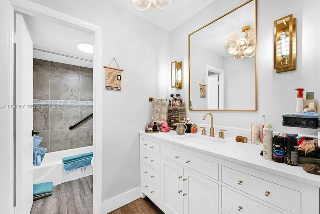 a bathroom with a sink mirror and vanity