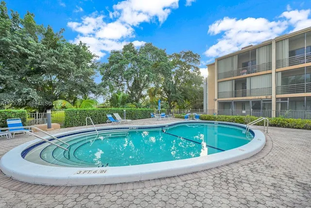 a view of a swimming pool with a house in the background