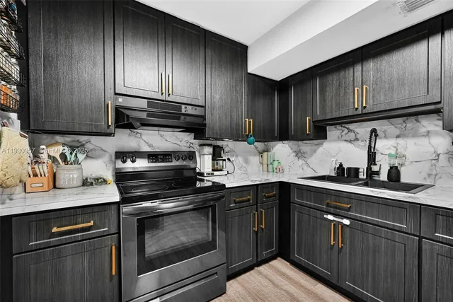 a kitchen with sink cabinets and stainless steel appliances