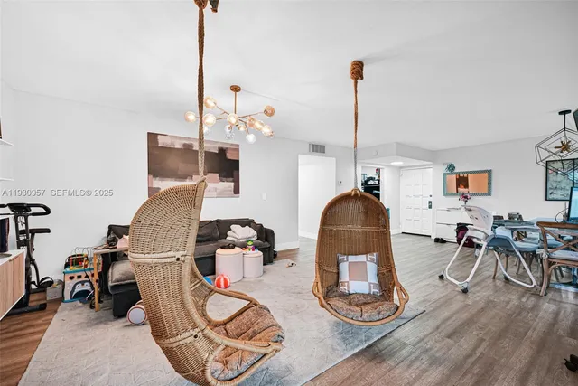 a living room with furniture dining table and a large window
