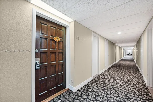 a view of a storage & utility room with fridge and racks