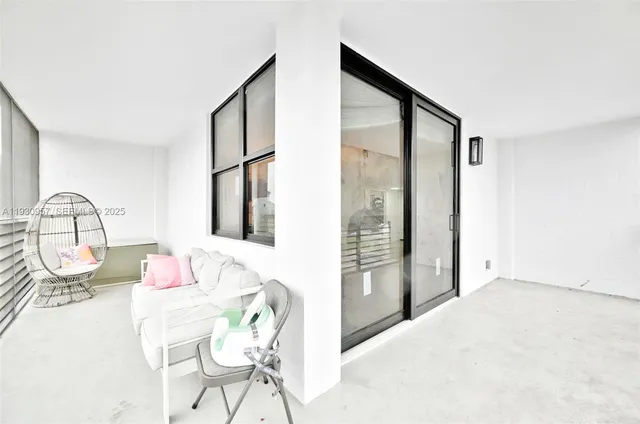 a bedroom with a bed and a large mirror with a bathroom