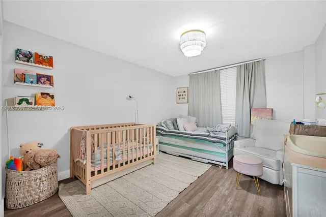 a living room with furniture and a baby crib