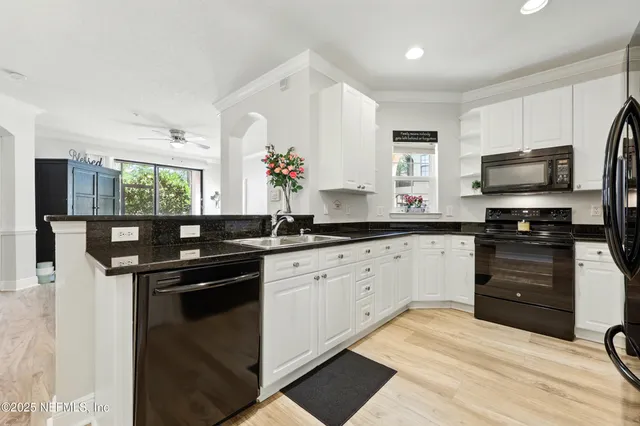 a kitchen with a sink stove and microwave