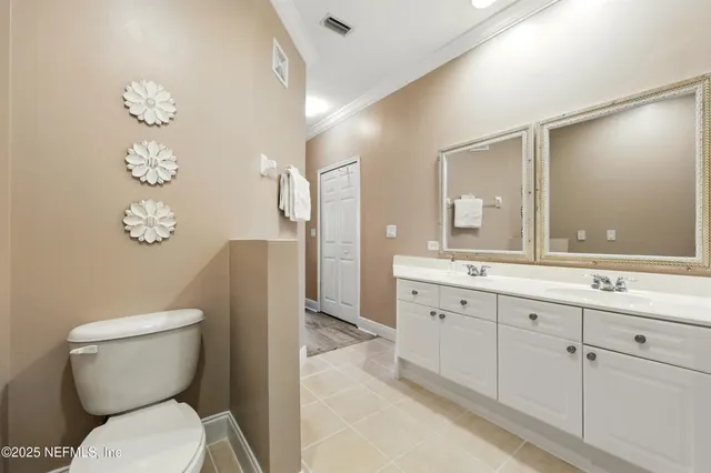 a bathroom with a granite countertop toilet sink and mirror