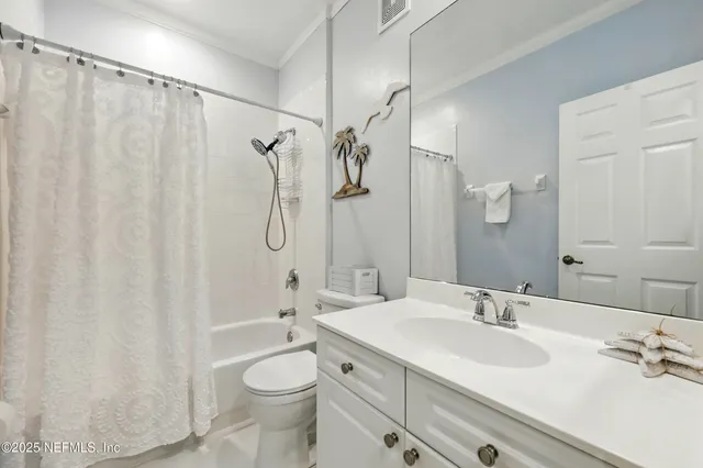 a bathroom with a double vanity sink toilet mirror and shower