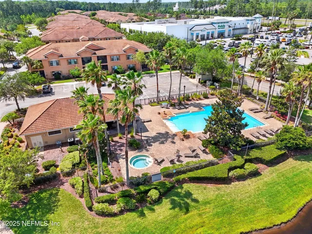 a view of a swimming pool with a garden and plants