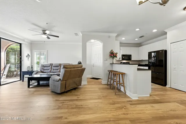 a living room with furniture and kitchen view