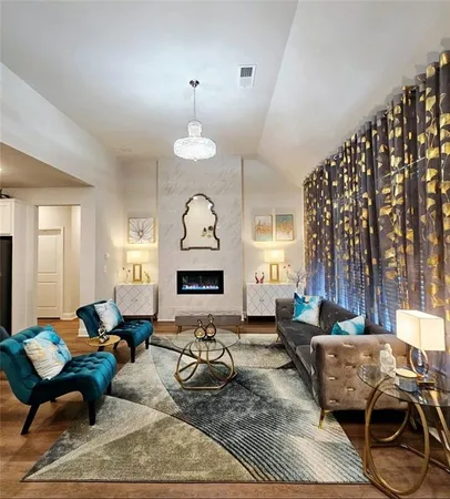 a living room with furniture a fireplace and a large window