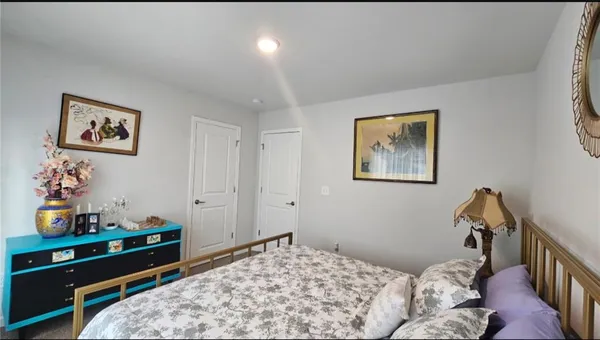a bedroom with a bed and a couch