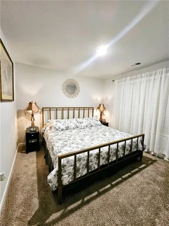 a bedroom with a bed and lamp