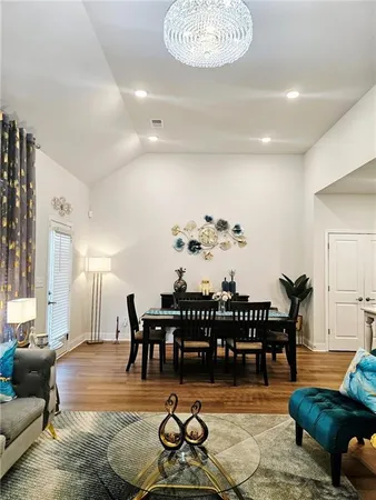 a living room with furniture a rug and a chandelier