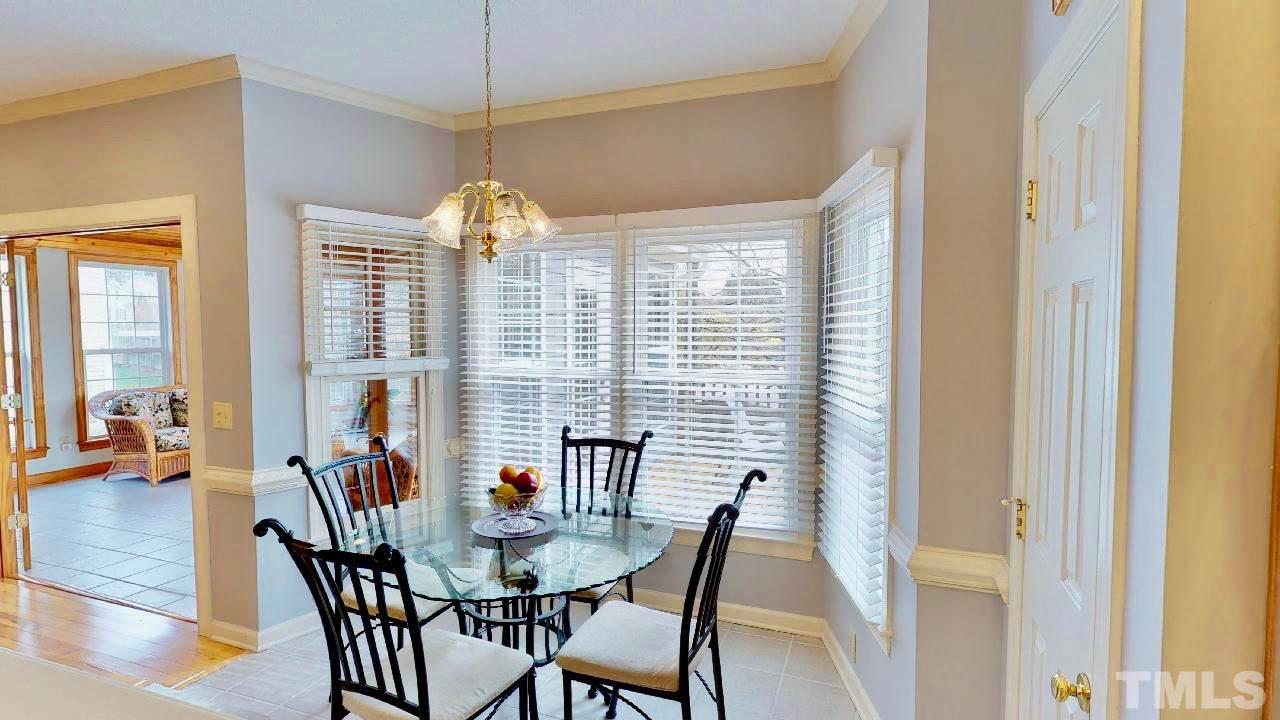 7504 Boscobel Way Raleigh, NC 27615 - Photo 11 of 25 a view of a dining room with furniture window and wooden floor