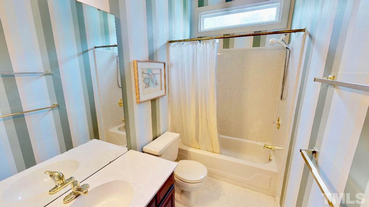 7504 Boscobel Way Raleigh, NC 27615 - Photo 15 of 25 a bathroom with a sink toilet and shower