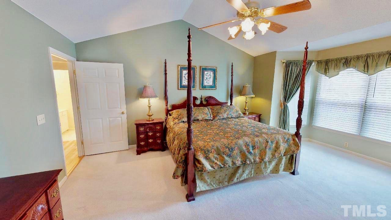 7504 Boscobel Way Raleigh, NC 27615 - Photo 17 of 25 a bed sitting in a bedroom next to a window