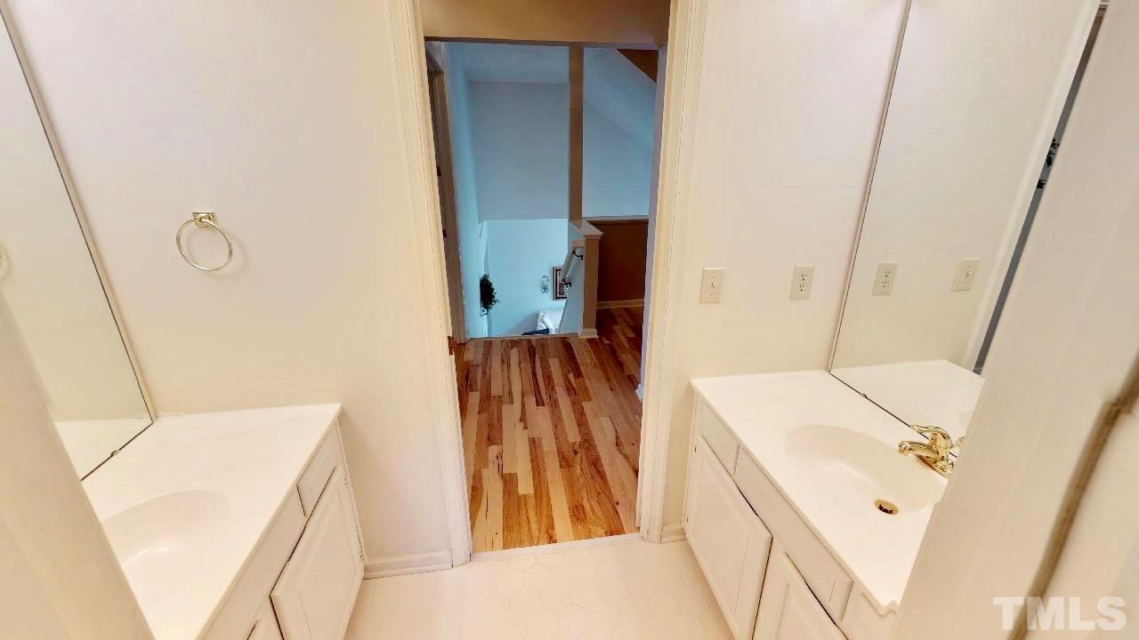 7504 Boscobel Way Raleigh, NC 27615 - Photo 20 of 25 a bathroom with a sink and mirror