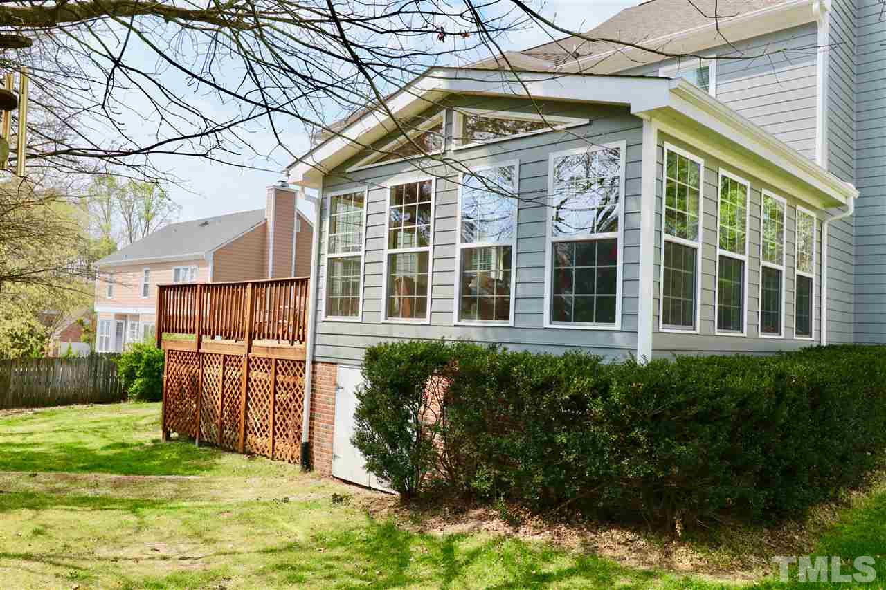 7504 Boscobel Way Raleigh, NC 27615 - Photo 3 of 25 a view of a house with a small yard and wooden fence