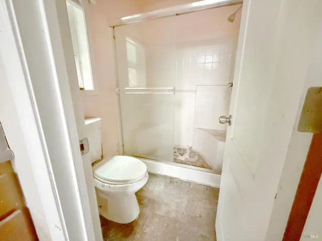 a bathroom with a granite countertop sink a mirror and a shower