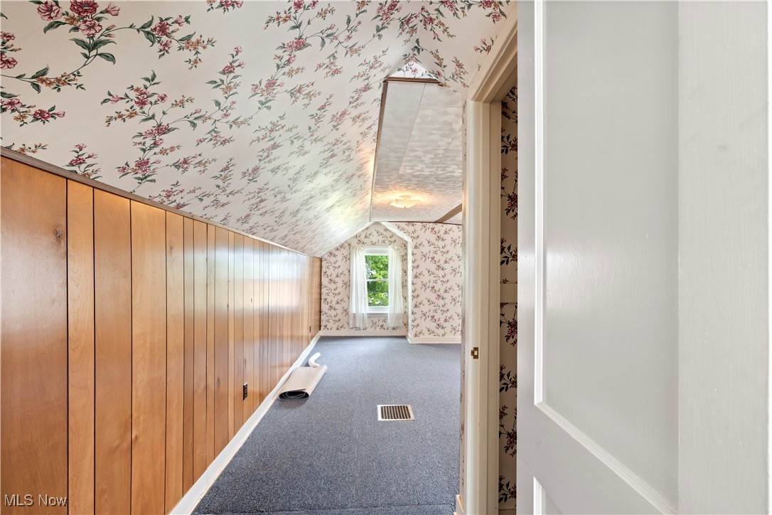 61 Ledge Road Northfield, OH 44067 - Photo 14 of 23 Bonus room with lofted ceiling, wooden walls, and carpet