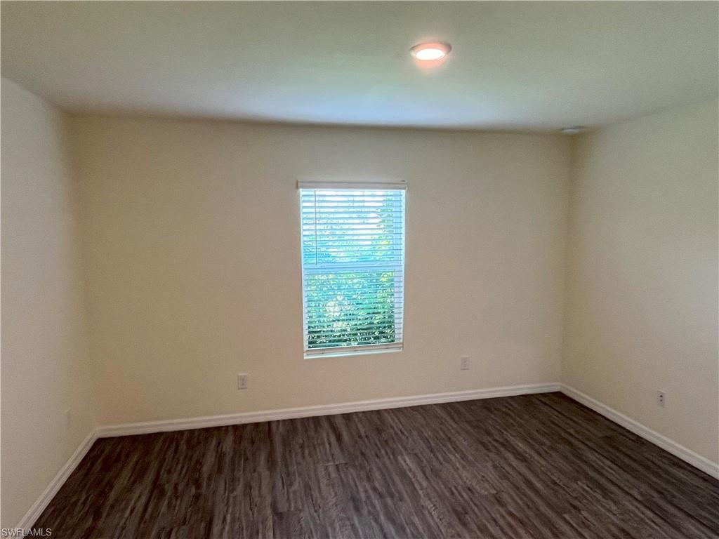 1187 Highlands Road Punta Gorda, FL 33983 - Photo 13 of 21 an empty room with wooden floor and windows