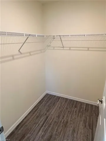 a bathroom with a granite countertop toilet a sink and a mirror