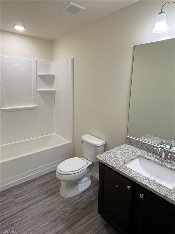 1187 Highlands Road Punta Gorda, FL 33983 - Photo 15 of 21 a bathroom with a granite countertop toilet a sink and a mirror