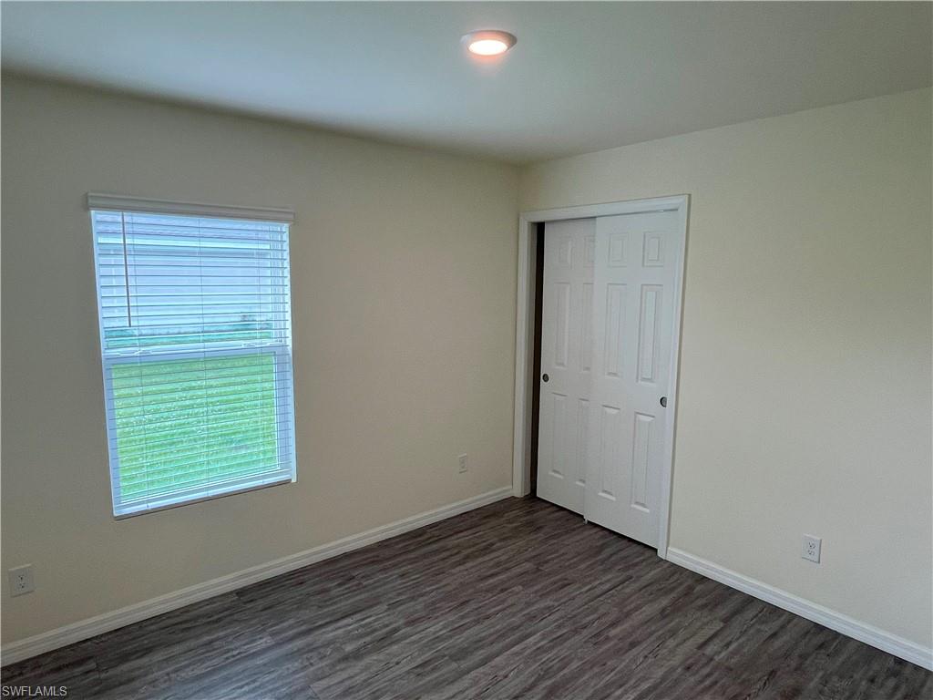 1187 Highlands Road Punta Gorda, FL 33983 - Photo 17 of 21 a view of an empty room with wooden floor and a window